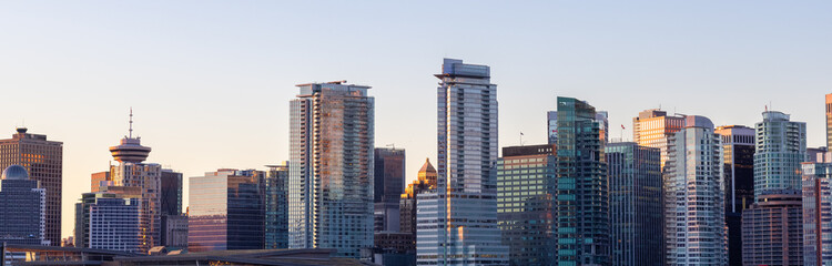 Fototapeta na wymiar Panoramic View of Modern City Building Skyline. Sunny Winter Sunrise. Coal Harbour, Downtown Vancouver, British Columbia, Canada. Cityscape Panorama Background