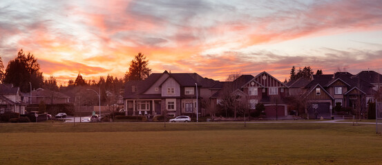 Panoramic View of Residential Homes in a modern city suburban neighborhood. Cloudy Winter Sunset...