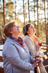 Fototapeta premium Two middle-aged women in spring park