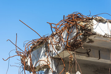 Metal fittings wire rusty twisted into the overlapping old building.