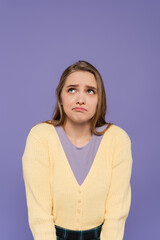 Fototapeta premium confused young woman looking away isolated on purple.