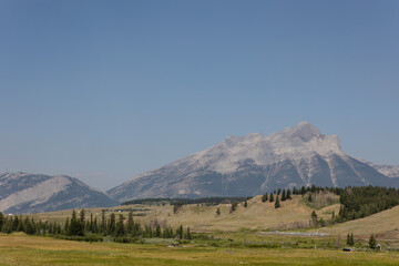 Landscape of snow-capped Crowsnest Mountain with beautiful summer skies