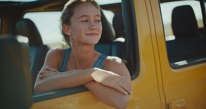 Beautiful young blond woman relaxing and enjoying life on epic road trip, freedom and travel lifestyle