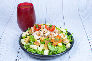 Traditional mix of salad and fresh vegetables, displayed in a black craft container