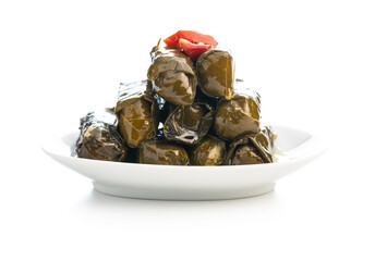 Dolmades. Stuffed vine leaves. Greek appetizer on plate isolated on white background.