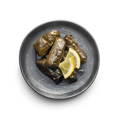 Dolmades. Stuffed vine leaves. Greek appetizer on plate isolated on white background.