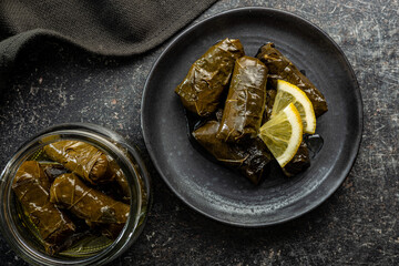 Dolmades. Stuffed vine leaves. Greek appetizer on plate.