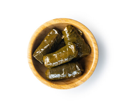 Dolmades. Stuffed vine leaves. Greek appetizer in bowl isolated on white background.