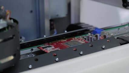 Close up view: automated visual optical inspection system for quality control of printed circuit board. Industrial, robotic, measurement, production, technology and manufacturing concept