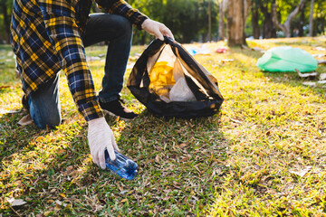 Obraz premium Collecting the garbage and separating waste to freshen the problem of environmental pollution and global warming, plastic waste, care for nature. Volunteer concept of men carrying garbage bags