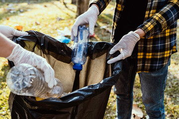 Collecting the garbage and separating waste to freshen the problem of environmental pollution and global warming, plastic waste, care for nature. Volunteer concept of men carrying garbage bags