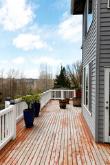 Vertical layout of home outdoor deck during spring time with maintenance to wooden planks