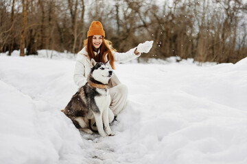 woman with dog on the snow walk play rest winter holidays