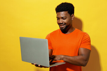 Young freelancer copywriter cool fun student smiling man of African American ethnicity 20s wear...
