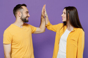 Young happy couple two friends family man woman together in yellow casual clothes meeting together...