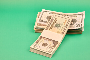 A pile of dollars on a green table. Photograph in horizontal format. Copy space. 