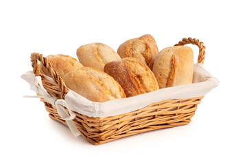 Fresh wheat buns in a wicker basket isolated on a white background
