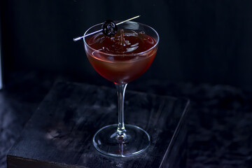 A Manhattan Cocktail garnished with a cherry