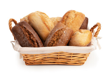 Fresh wheat and rye buns in a wicker basket isolated on a white background