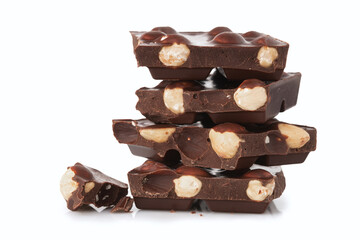 Stack of dark chocolate pieces with nuts isolated on a white background