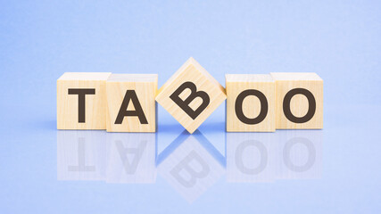 text Taboo - letters by on woodens blocks on pale lilac background, in concept of business and...