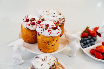 decorated panettones and cruffins on serving plates with rabbits. easter cakes. 