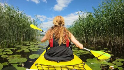 Active young woman paddling on an kayak on in Finland. Family Sports. Summer. Travel. Tourism