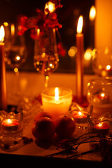 romantic evening with candles, champagne and tangerines