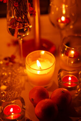 romantic evening with candles, champagne and tangerines
