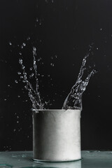 Naklejka na ściany i meble Splashes of water in a plaster pot