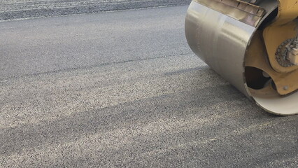 Repair new road asphalting roller. Applying hot resin sidewalk. Industrial equipment with smooth...