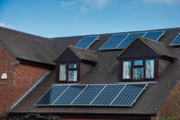 Old traditional English house roof with solar panels