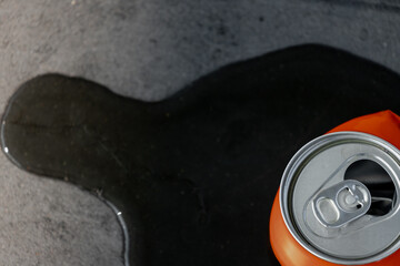 Littering campaign and recycling concept, Leaking water on the side of an aluminium can, Top view...