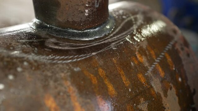 Checking the weld seam with water. Manufacture of pipes for water. Heavy metal industry.