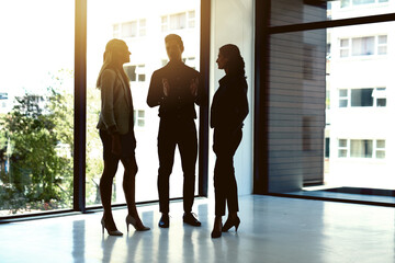 Bringing their bold business vision together. Shot of a group of businesspeople having a discussion...