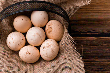 natural chicken eggs in a black basket
