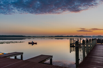 Fototapeta na wymiar fishing in lake in sunset