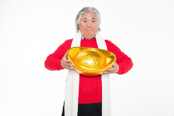 older persons holding a gold ingot