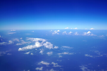 View of the sea and some clouds from an airplane's window.