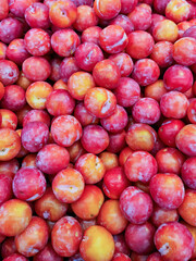 red plums stack in market