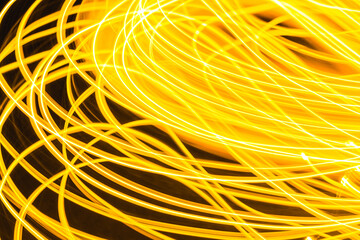 Abstract background freezelight burst of golden spiral bands of light on a black.