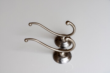 Stainless steel hooks on white background with copy space