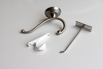Different wall hooks on white background