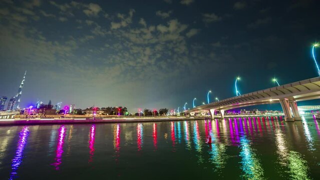 night illumination dubai canal reflection downtown crossing bridge panorama 4k time lapse uae