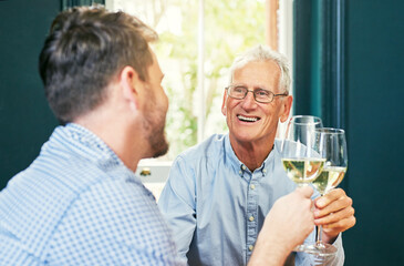 Heres to you and me dad. Shot of a cheerful elderly man and his son sharing a celebratory toast with wine glasses at home.