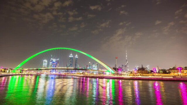 dubai water canal night illuminated crossing bridge downtown panorama 4k time lapse uae