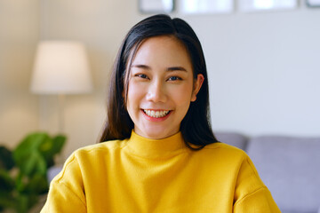 Portrait of young Asian woman smile and look at camera