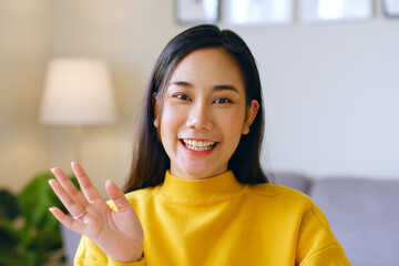 Portrait Young Asian woman talking on video call or virtual meeting, front view, look at camera