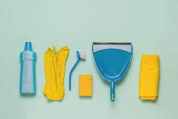Yellow and blue cleaning and cleaning kit on a light background. Space for text. Flat lay.