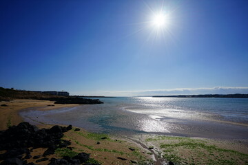 clear shoaling beach and the sun